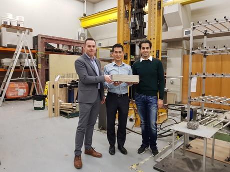 Image caption: Damian Crough, Assoc Prof Tuan Ngo and Dr Ali Kashani in the lab with a block of glass-impregnated concrete